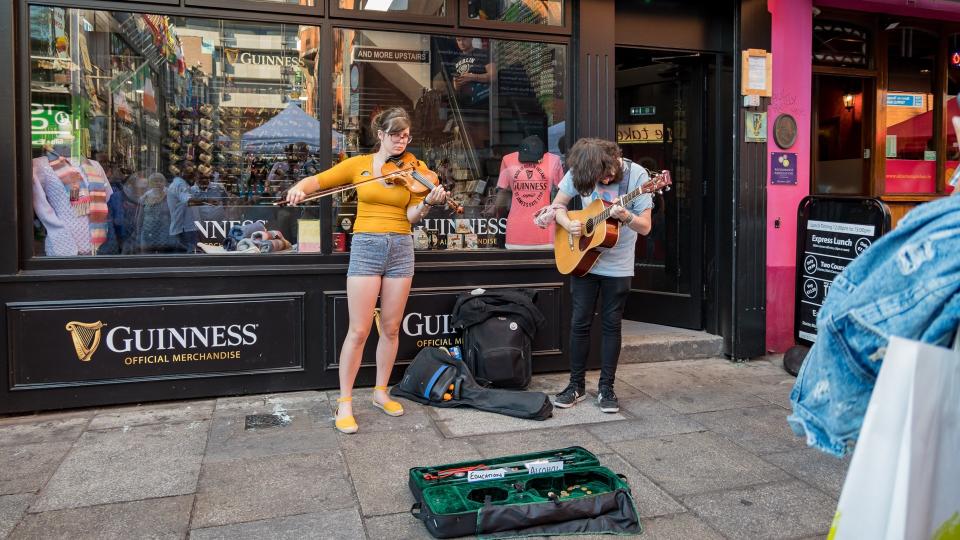 Dublin, JUL 1: Street artist performing music with violin and guitar on JUL 1, 2018 at Dublin, Ireland.