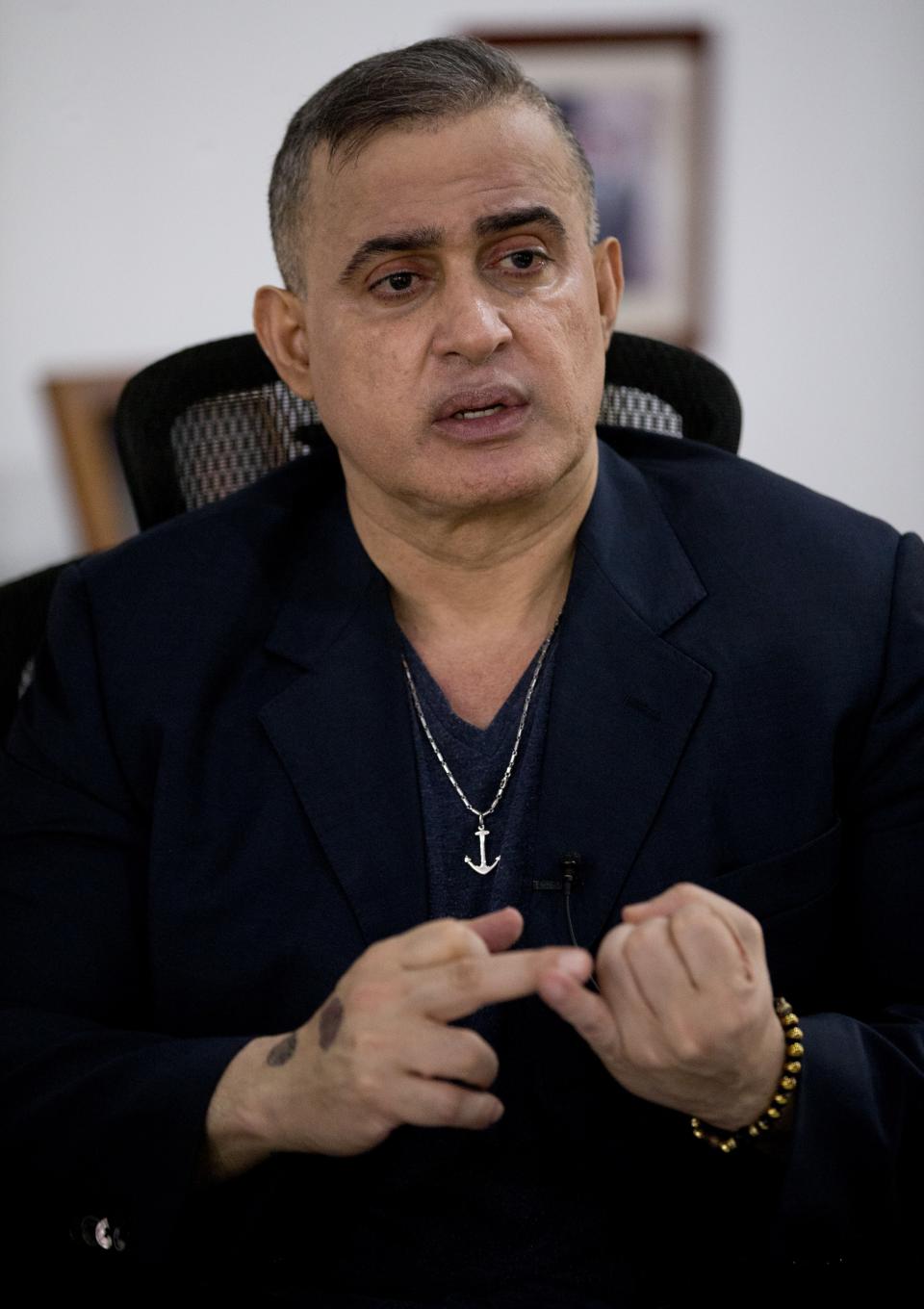 Venezuela's Chief Prosecutor Tarek William Saab speaks during a interview with the Associated Press at his office in Caracas, Venezuela, Thursday, Oct. 18, 2018. Saab said he is investigating the police officers who failed to keep safe an opposition politician who plunged from the 10th-floor of a high-security building even as he rejects calls for an independent probe into what authorities contend was a suicide. (AP Photo/Ariana Cubillos)