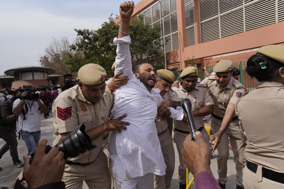 Policemen detain a member of Aam Admi Party, or Common Man's Party, during a protest against the arrest of their party leader Arvind Kejriwal in New Delhi, India, Tuesday, March 26, 2024. Indian police have detained dozens of opposition protesters and prevented them from marching to Prime Minister Narendra Modi’s residence to demand the release of their leader and top elected official of New Delhi who was arrested last week in a liquor bribery case. (AP Photo/Manish Swarup)