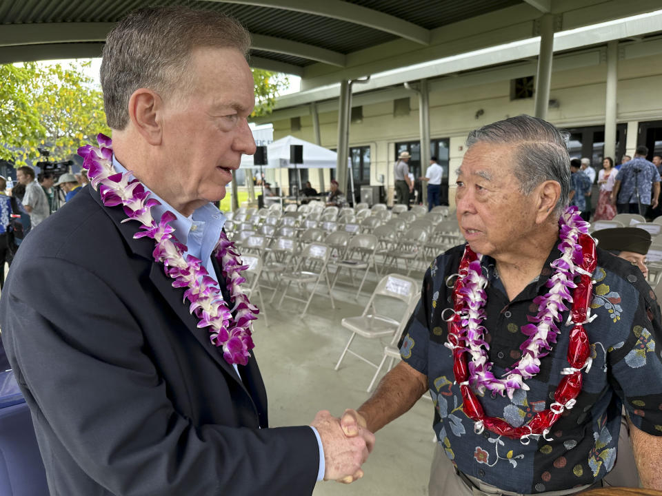 Wilfred Ikemoto, right, whose older brother Haruyuki Ikemoto posthumously received a Purple Heart medal after being killed in World War II, thanks researcher Daniel Matthews in Pearl Harbor, Hawaii, on Friday, May 10, 2024. The families of five Hawaii men who served in a unit of Japanese-language linguists during World War II received posthumous Purple Heart medals on behalf of their loved ones on Friday, nearly eight decades after the soldiers died in a plane crash in the final days of the conflict. (AP Photo/Audrey McAvoy)