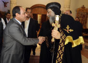 Egypt's former military chief Abdel-Fattah el-Sissi, shakes hands with Coptic Pope Tawadros II at Cairo’s St. Mark’s Cathedral, seat of the Coptic Orthodox Pope, in Cairo, Egypt, Saturday, April 19, 2014. El-Sissi on Monday took the final formal step to run in next month's presidential election, submitting to the election commission eight times the number of signatures required. He is widely expected to win. (AP Photo/Girgis Mahboub, Office of the Coptic Pope)