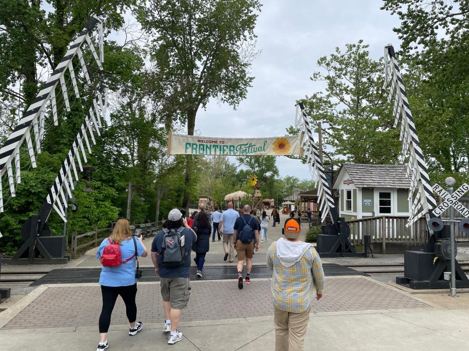 Guests walk into Cedar Point's Frontier Town that will host an adults-only afterhours event on select nights in June.