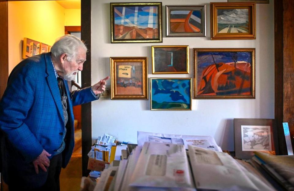 Fred McCraw, a friend of the late artist Thomas Hart Benton, discusses some of his own paintings in his home in Merriam.