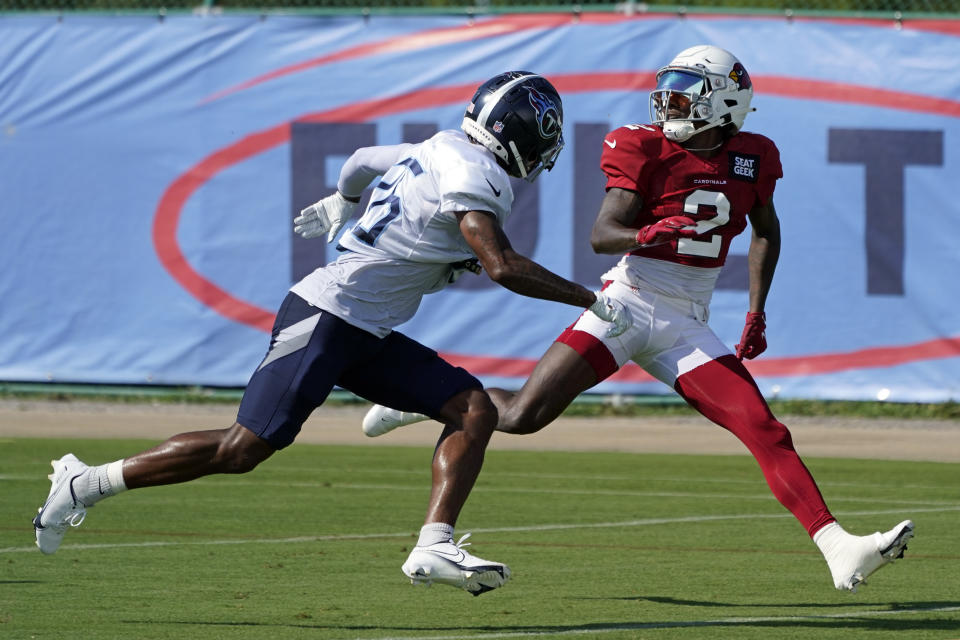 Tennessee Titans cornerback Kristian Fulton (26) runs a drill with Arizona Cardinals wide receiver Marquise Brown (2) during NFL football training camp Wednesday, Aug. 24, 2022, in Nashville, Tenn. The Titans and Cardinals are holding a training camp practice together. (AP Photo/Mark Humphrey)