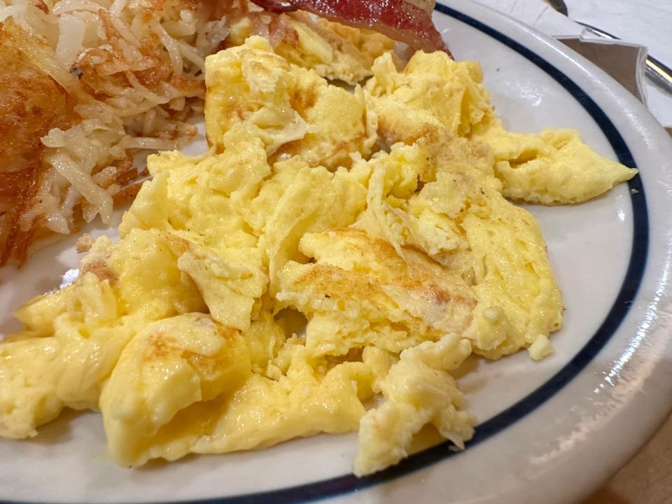 Yellow scrambled eggs on white plate at IHOP