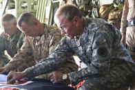 BAGRAM, AFGHANISTAN - AUGUST 21: In this handout image provided by The New Zealand Defence Force, U.S. Chairman Joint Chiefs of Staff Gen Martin Dempsey (R) and COMISAF General John Allen (2md L) pay their respect during a ramp ceremony for Corporal Luke Tamatea, Lance Corporal Jacinda Baker and Private Richard Harris at Bagram Air Base on August 21, 2012 in Bagram, Afghanistan. The three New Zealand soldiers where killed in Afghanistan on August 19 after their vehicle was hit by a roadside bomb. (Photo by The New Zealand Defence Force via Getty Images)