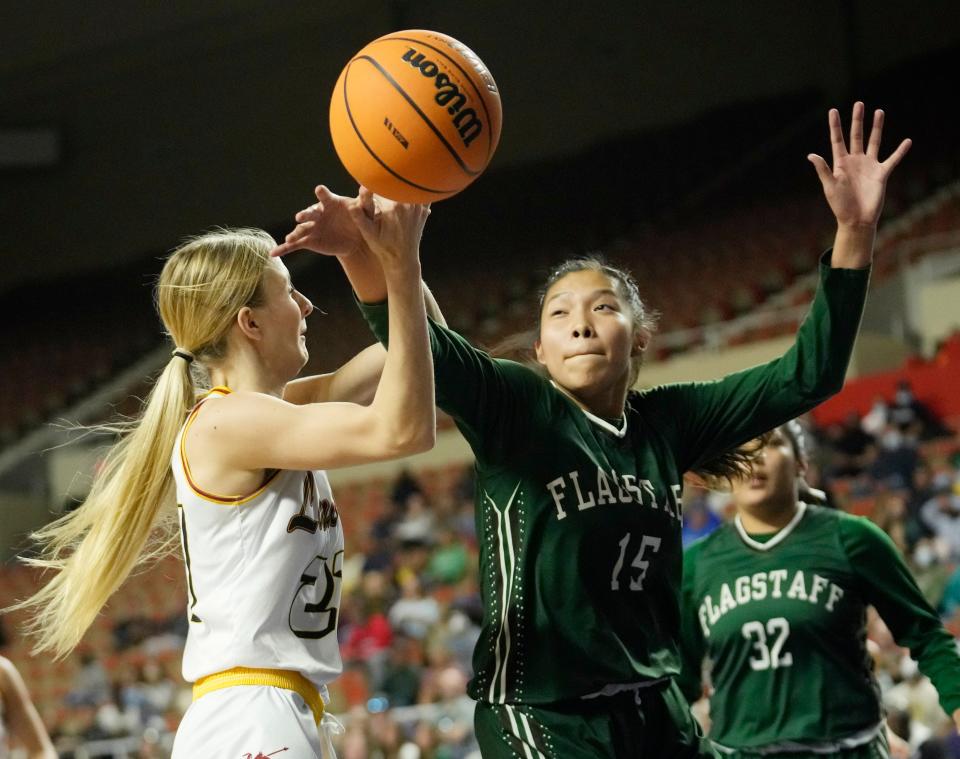 Feb 28, 2022; Phoenix, Ariz., U.S.;  Flagstaff guard/forward Gracelyn Nez (15) deflects the ball away from Salpointe Catholic guard Tessa Hastings (21) during the 4A state girls basketball championship game at Arizona Veterans Memorial Coliseum.