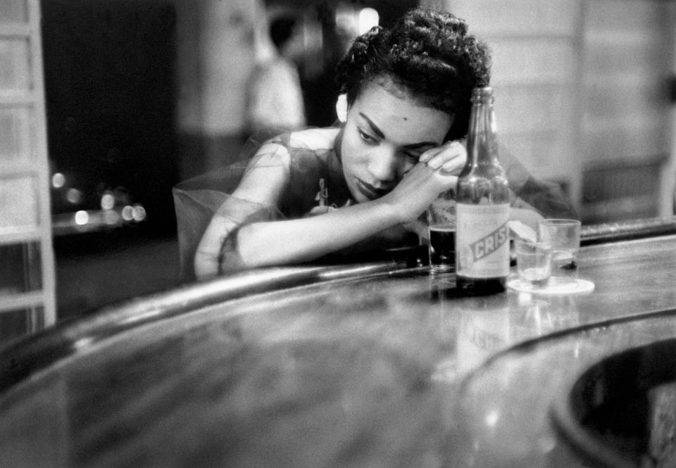 <p>Bar girl in a brothel in the red-light district, Havana, Cuba, 1954. “I have been poor and I wanted to document poverty; I had lost a child and I was obsessed with birth; I was interested in politics and I wanted to know how it affected our lives; I am a woman and I wanted to know about women.” (© Eve Arnold/Magnum Photos) </p>