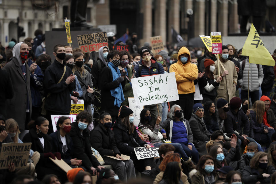 Demonstrators holding posters and flags gather at Parliament Square during a 'Kill the Bill' protest in London, Saturday, April 3, 2021. The demonstration is against the contentious Police, Crime, Sentencing and Courts Bill, which is currently going through Parliament and would give police stronger powers to restrict protests. (AP Photo/Matt Dunham)