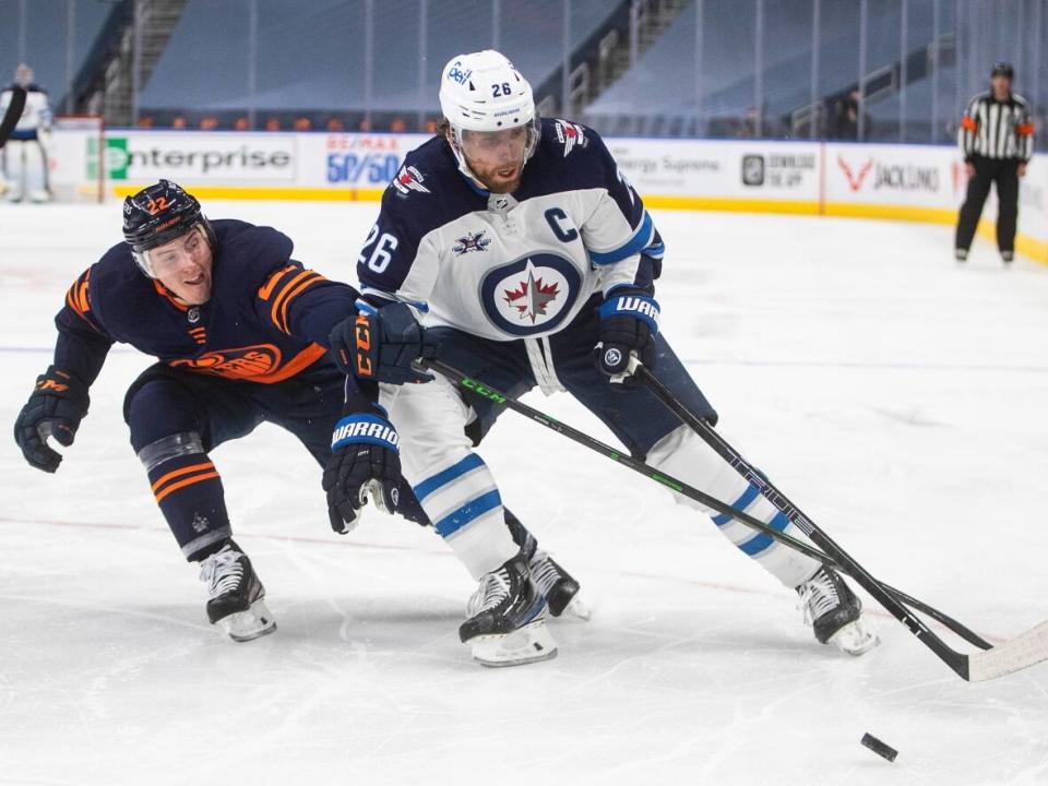 Winnipeg Jets captain Blake Wheeler, right, has entered the NHL's COVID-19 protocols.  (Jason Franson/The Canadian Press - image credit)