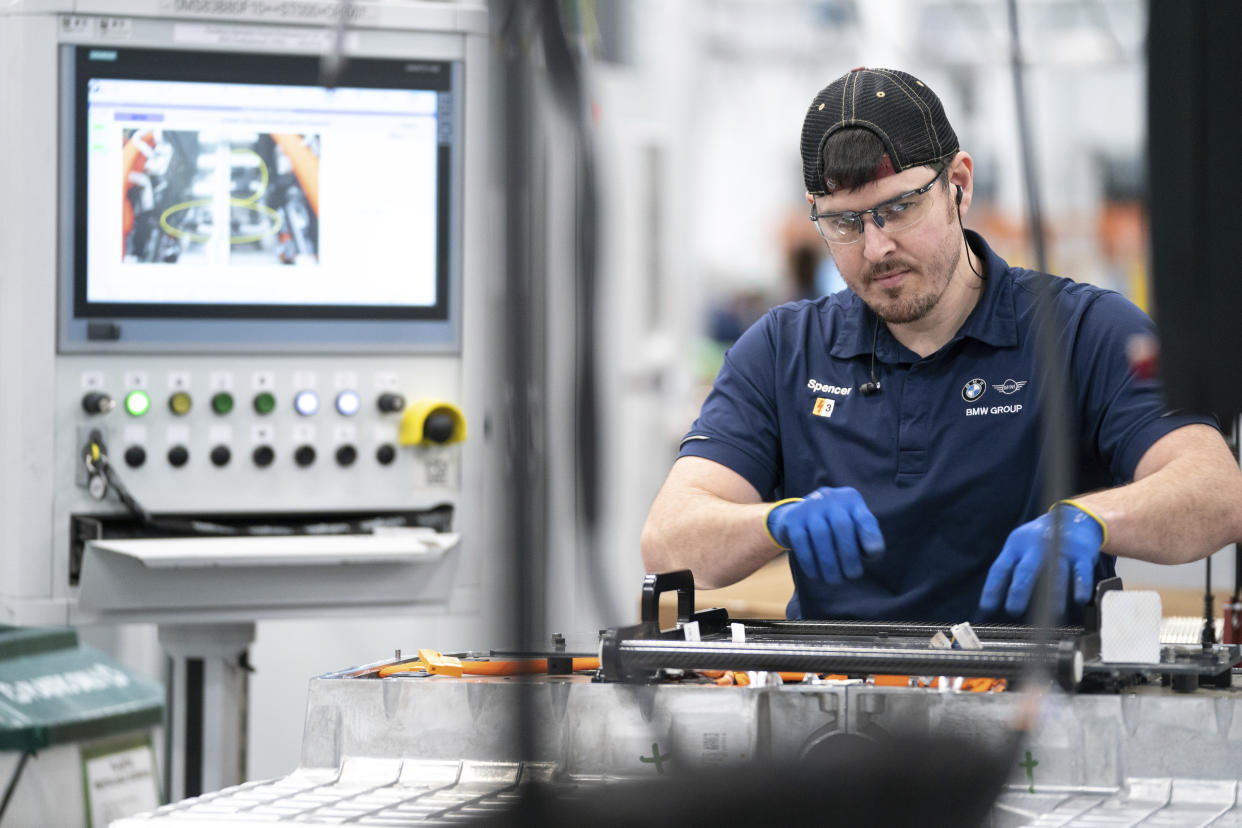 FILE - An employee works in the battery assembly hall at the BMW Spartanburg plant in Greer, S.C., Wednesday, October 19, 2022. On Thursday, the Commerce Department issues its first of three estimates of how the U.S. economy performed in the fourth quarter of 2022.(AP Photo/Sean Rayford, File)