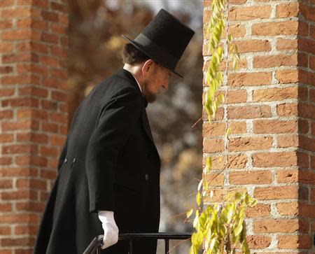 U.S. President Abraham Lincoln, portrayed by James Getty, walks onstage at the Gettysburg National Cemetery in Pennsylvania November 19, 2013, the burial ground for Civil War Union soldiers in which U.S. President Abraham Lincoln travelled to in 1863 to deliver a few concluding remarks at a formal dedication. REUTERS/Gary Cameron