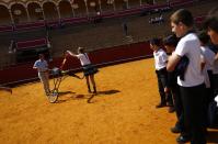 A student drives banderillas into a simulated bull during a bullfight master class for schoolchildren at the Maestranza bullring in the Andalusian capital of Seville, southern Spain, April 23, 2014.