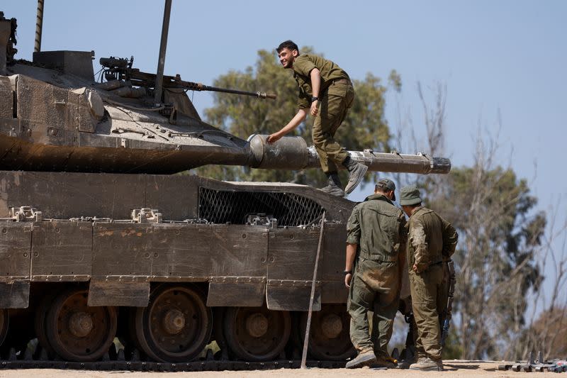 Israeli military vehicles manoeuvre, near the Israel-Gaza border