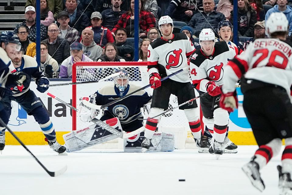 Feb 14, 2023; Columbus, Ohio, USA;  Columbus Blue Jackets goaltender Elvis Merzlikins (90) watches New Jersey Devils defenseman Damon Severson (28) handle the puck during the third period of the NHL hockey game at Nationwide Arena. The Blue Jackets lost 3-2. Mandatory Credit: Adam Cairns-The Columbus Dispatch