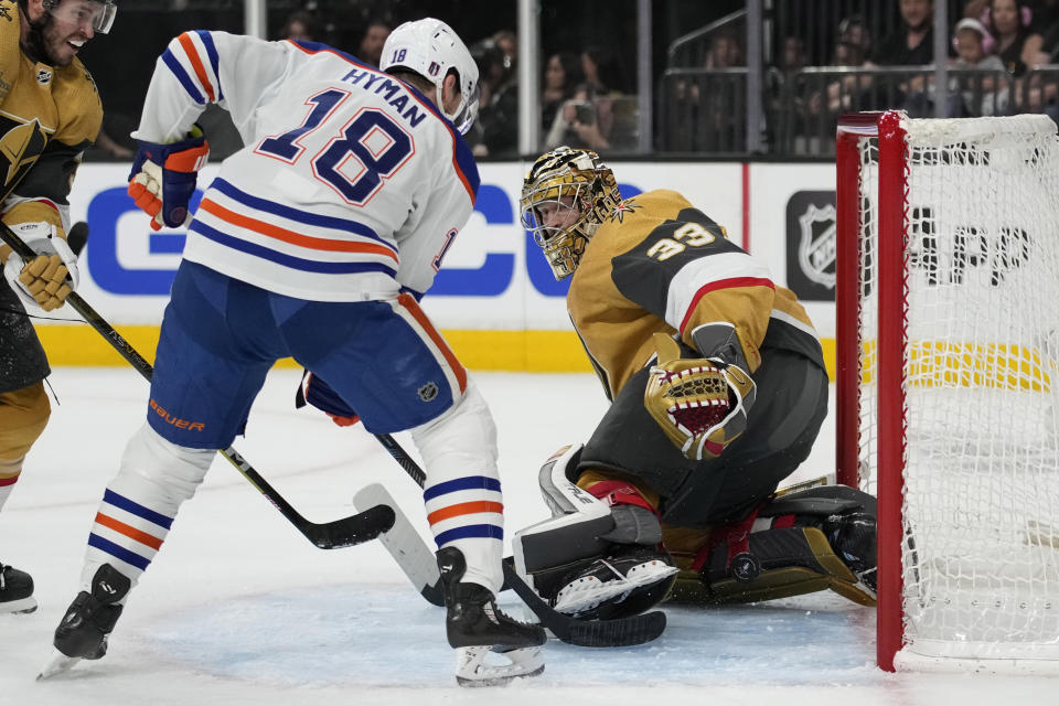 Edmonton Oilers left wing Zach Hyman (18) scores against Vegas Golden Knights goaltender Adin Hill (33) during the first period of Game 5 of an NHL hockey Stanley Cup second-round playoff series Friday, May 12, 2023, in Las Vegas. (AP Photo/John Locher)