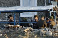 A North Korean soldier aims his rifle at a Chinese tourist boat as he and other soldiers stand guard on the banks of Yalu River, some 100 kilometers (62 miles) from the North Korean town of Sinuiju, opposite the Chinese border city of Dandong, December 16, 2013. U.S. Secretary of State John Kerry described North Korea's Kim Jong Un as reckless and insecure after the execution of the leader's powerful uncle, and said Kim's actions underscored a need for a unified stand against Pyongyang's nuclear program. Picture taken December 16, 2013. (REUTERS/Jacky Chen)