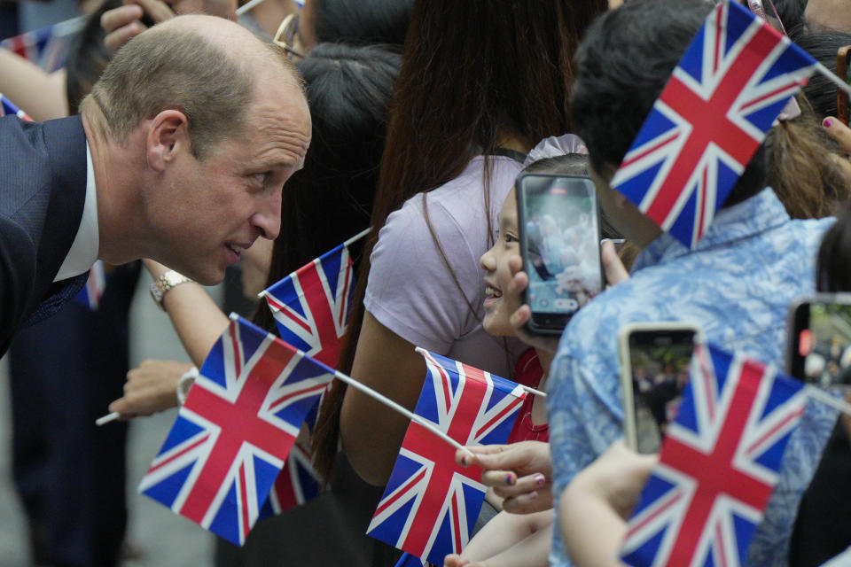 Britain's Prince William, left, chats with a local children as he arrives at Jewel Changi airport, Singapore, Sunday, Nov. 5, 2023. (AP Photo/Vincent Thian)