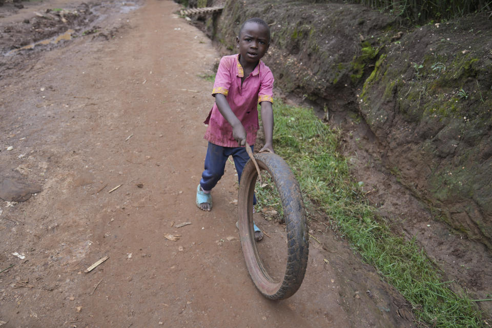 A young Rwandan boy plays with a tyre in Gahanga the outskirts of Kigali, Rwanda, Tuesday, April 4, 2024. The country will commemorate on April 7, 2024 the 30th anniversary of the genocide when ethnic Hutu extremists killed neighbours, friends and family during a three-month rampage of violence aimed at ethnic Tutsis and some moderate Hutus, leaving a death toll that Rwanda puts at 1,000,050. (AP Photo/Brian Inganga)