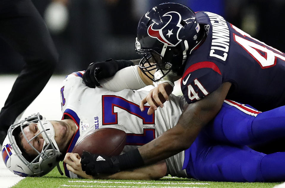 HOUSTON, TEXAS - JANUARY 04: Quarterback Josh Allen #17 of the Buffalo Bills  is tackled by inside linebacker Zach Cunningham #41 of the Houston Texans during the AFC Wild Card Playoff game at NRG Stadium on January 04, 2020 in Houston, Texas. (Photo by Tim Warner/Getty Images)