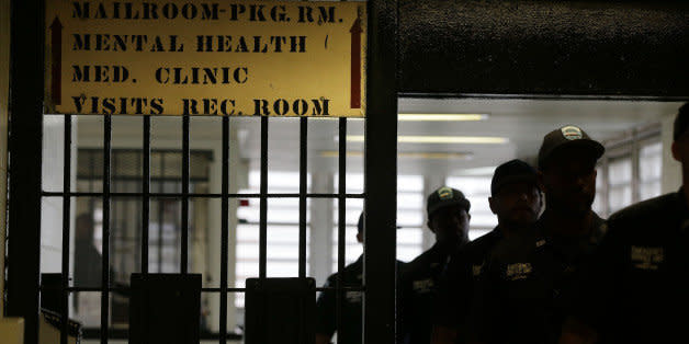 Rikers Island emergency services personnel walk through one of many gates inside the jail's juvenile detention facility, Thursday, July 31, 2014, in New York. (AP Photo/Julie Jacobson) (Photo: )