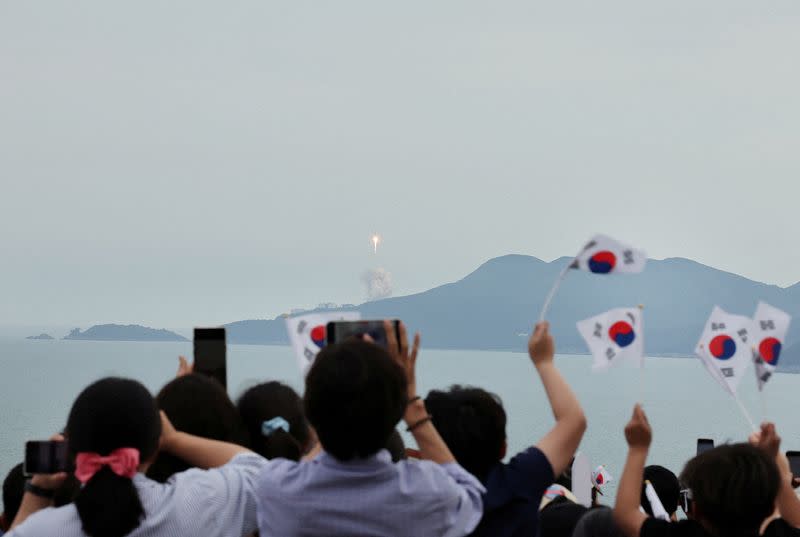 People watch the launch of South Korea’s homegrown Nuri space rocket in Goheung