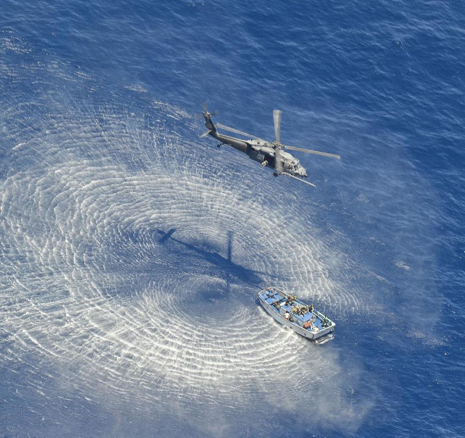 In this May 5, 2014 photo provided by the U.S. Air Force, a U.S. Air Force HH-60G Pavehawk helicopter from the 55th Rescue Squadron hovers 600 nautical miles off the Pacific Coast of Mexico to hoist two badly burned Chinese fishermen. The two were among 17 Chinese crew members believed aboard a fishing vessel that caught fire and sank in the Pacific Ocean. Two died from burn injuries, seven were determined to be in good condition and six are believed missing, said Maj. Sarah Schwennesen of Davis-Monthan Air Force Base in Tucson, Ariz. (AP Photo/U.S. Air Force, Staff Sgt. Adam Grant)