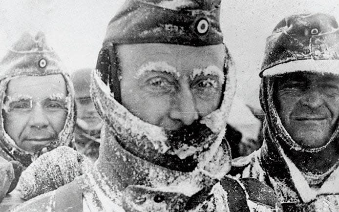 Three German soldiers covered in snow and ice during winter on the Eastern front - Getty Images