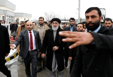 Former Afghan warlord Gulbuddin Hekmatyar (C) leaves after registering as a candidate for the presidential election at Afghanistan's Independent Election Commission (IEC) in Kabul, Afghanistan January 19, 2019.REUTERS/Mohammad Ismail