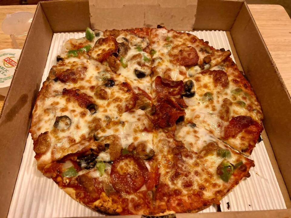 A “CowPie Deluxe” small pizza with pepperoni, Italian sausage, mushroom, green peppers, onions, black olives from CowPies Pizza Co.