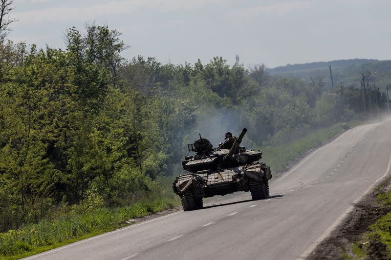 FILE PHOTO: A Ukrainian tank drives along a road near in Bakhmut, in the Donetsk region, Ukraine