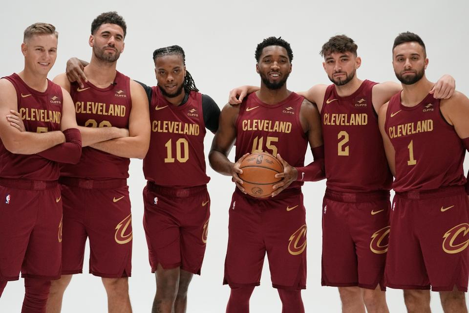 Cavaliers players, from left, Sam Merrill, Georges Niang, Darius Garland, Donovan Mitchell, Ty Jerome and Max Strus pose for a photo during media day, Monday, Oct. 2, 2023, in Cleveland.