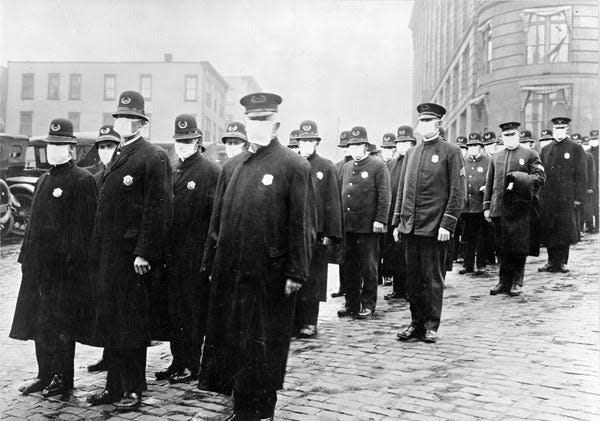 Policemen in Seattle wearing masks made by the Red Cross, during the influenza epidemic. December 1918.