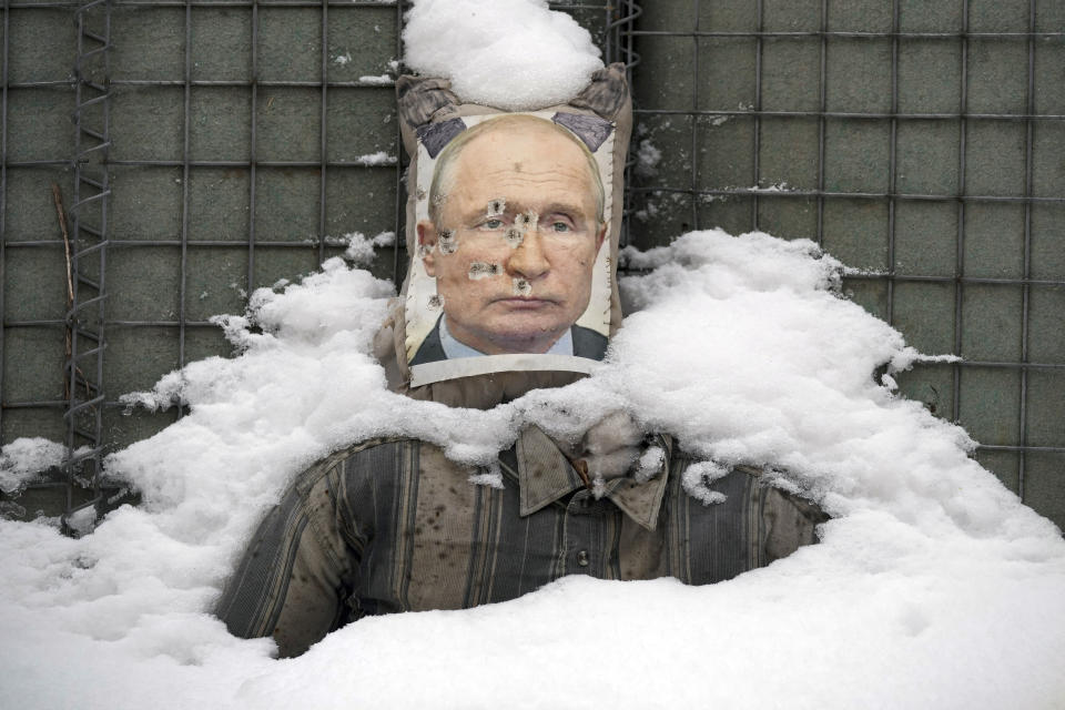 FILE- A bullet riddled effigy of Russian President Vladimir Putin, is coated by fresh snow at a frontline position in the Luhansk region, eastern Ukraine, Tuesday, Feb. 1, 2022. More than 100,000 Russian troops are currently massed along the Ukrainian border preparing for a possible invasion. Despite weeks of diplomacy, Putin still seems to hold all the cards, pushing Europe to the brink of war and prompting British Prime Minister Boris Johnson to call this the continent's "most dangerous moment" in decades. (AP Photo/Vadim Ghirda, File)