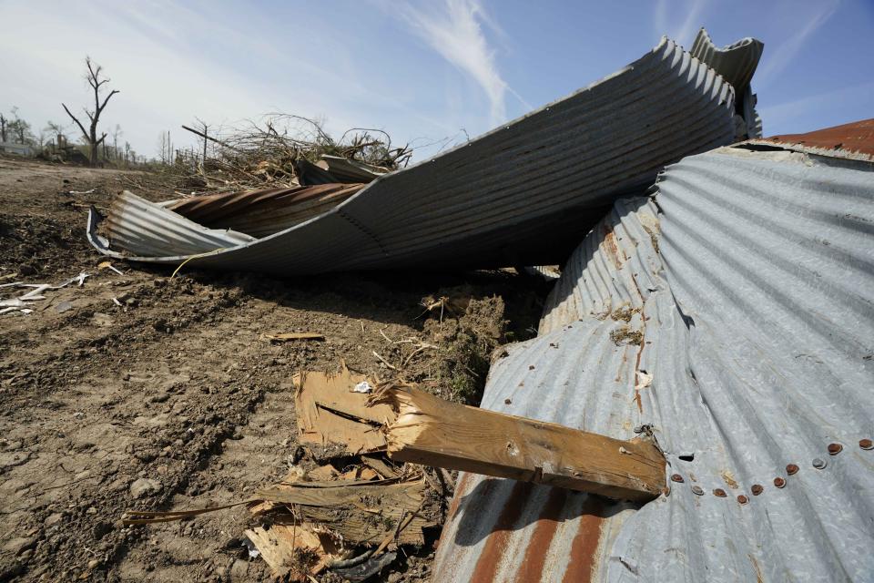 A wooden support beam pokes through a portion of a tin roof in Silver City, Miss., a testament to the strength of the Friday night killer tornado that hit a number of Mississippi communities, Tuesday, March 28, 2023. Many communities are in the midst of cleanup. (AP Photo/Rogelio V. Solis)