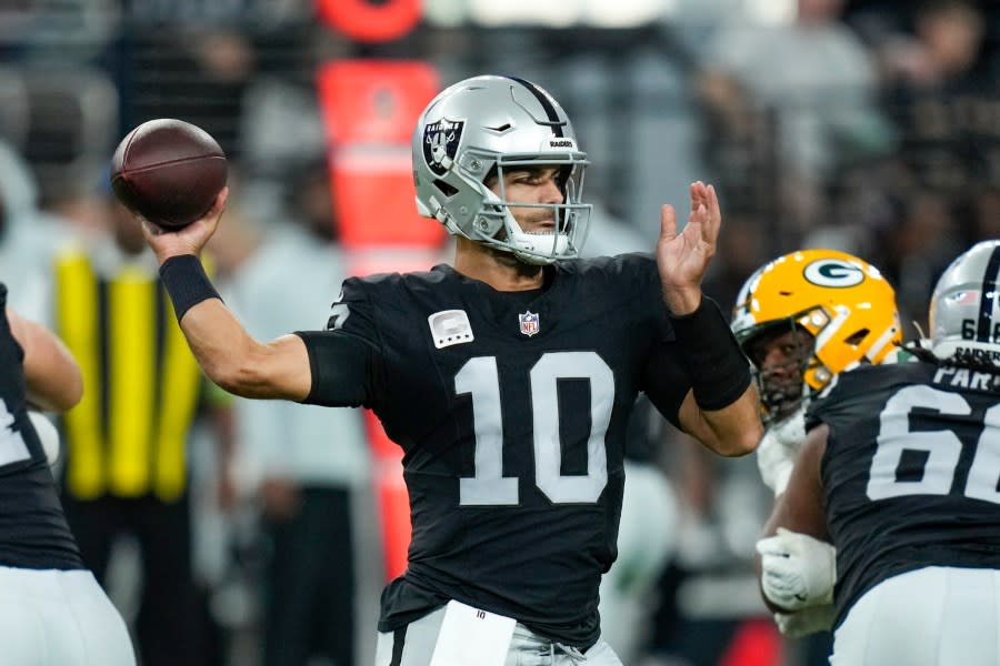 Las Vegas Raiders’ Jimmy Garoppolo throws a pass during the first half of an NFL football game against the Green Bay Packers Monday, Oct. 9, 2023, in Las Vegas. (AP Photo/John Locher)