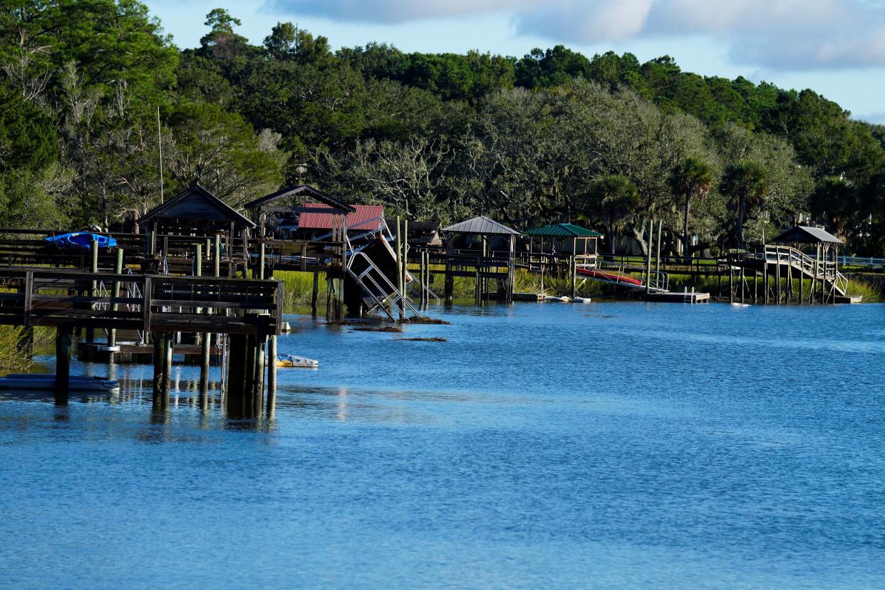 Docks on the the inlet between Pawleys Island and the mainland show damage following winds and rain from Hurricane Ian on Saturday, Oct. 1, 2022, in Pawleys Island, S.C.