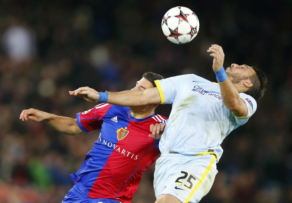 FC Basel's Fabian Schaer jumps for a header with Steaua Bucharest's Federico Piovaccari (R) during their Champions League Group E soccer match at St. Jakob-Park in Basel November 6, 2013. REUTERS/Arnd Wiegmann (SWITZERLAND - Tags: SPORT SOCCER)