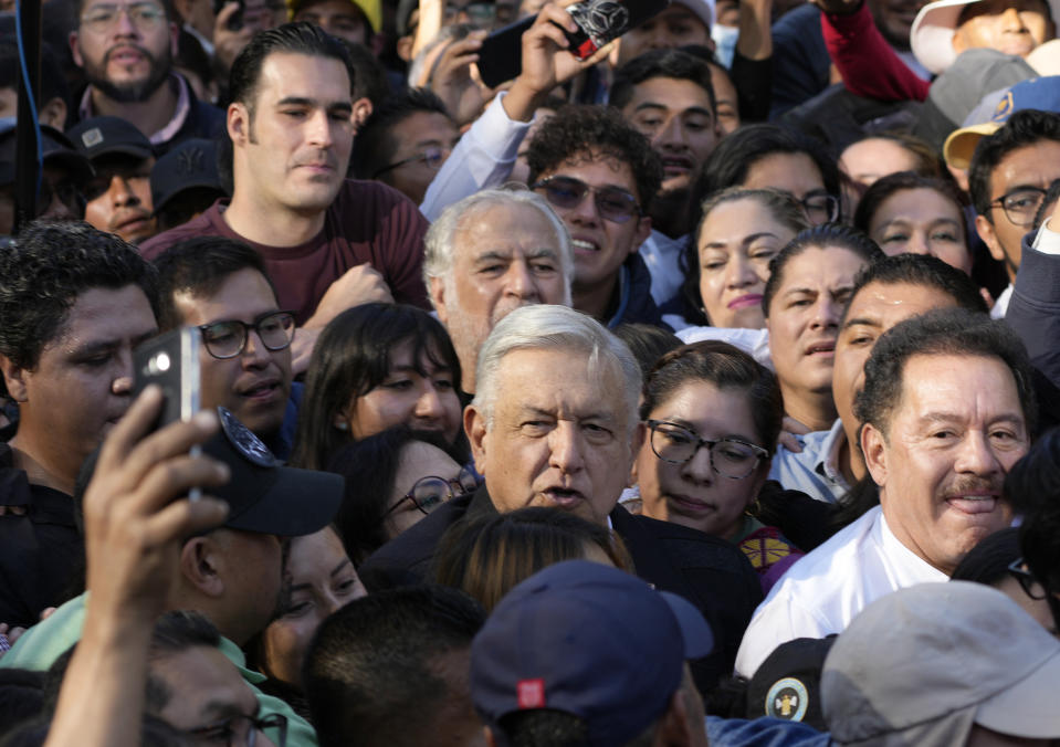 FILE - Mexico's President Andrés Manuel Lopez Obrador, center, and Mexican Sen. Ignacio Mier, far right, walk with supporters during a pro-government march, in Mexico City, Nov. 27, 2022. Legislators from the governing Morena party mistakenly submitted the wrong bill on pension reform for a vote in Congress in April 2024, before Mier and fellow Morena legislators admitted the error and rescheduled the vote. (AP Photo/Fernando Llano, File)
