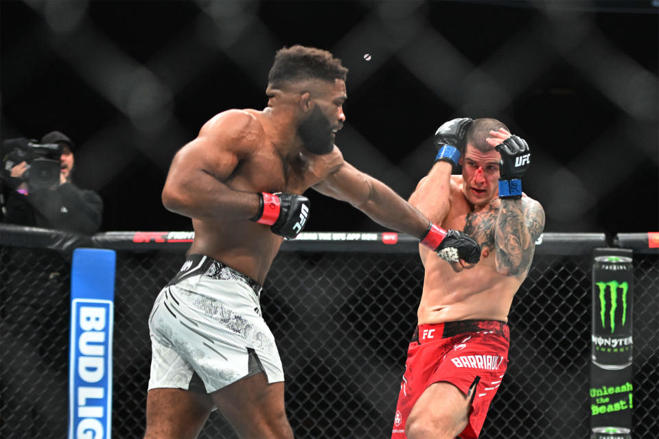 Jan 20, 2024; Toronto, Canada, USA; Chris Curtis (red glove) fights Marc-Andre Barriault (blue gloves) during UFC 297 at ScotiaBank Arena. Mandatory Credit: Dan Hamilton-USA TODAY Sports