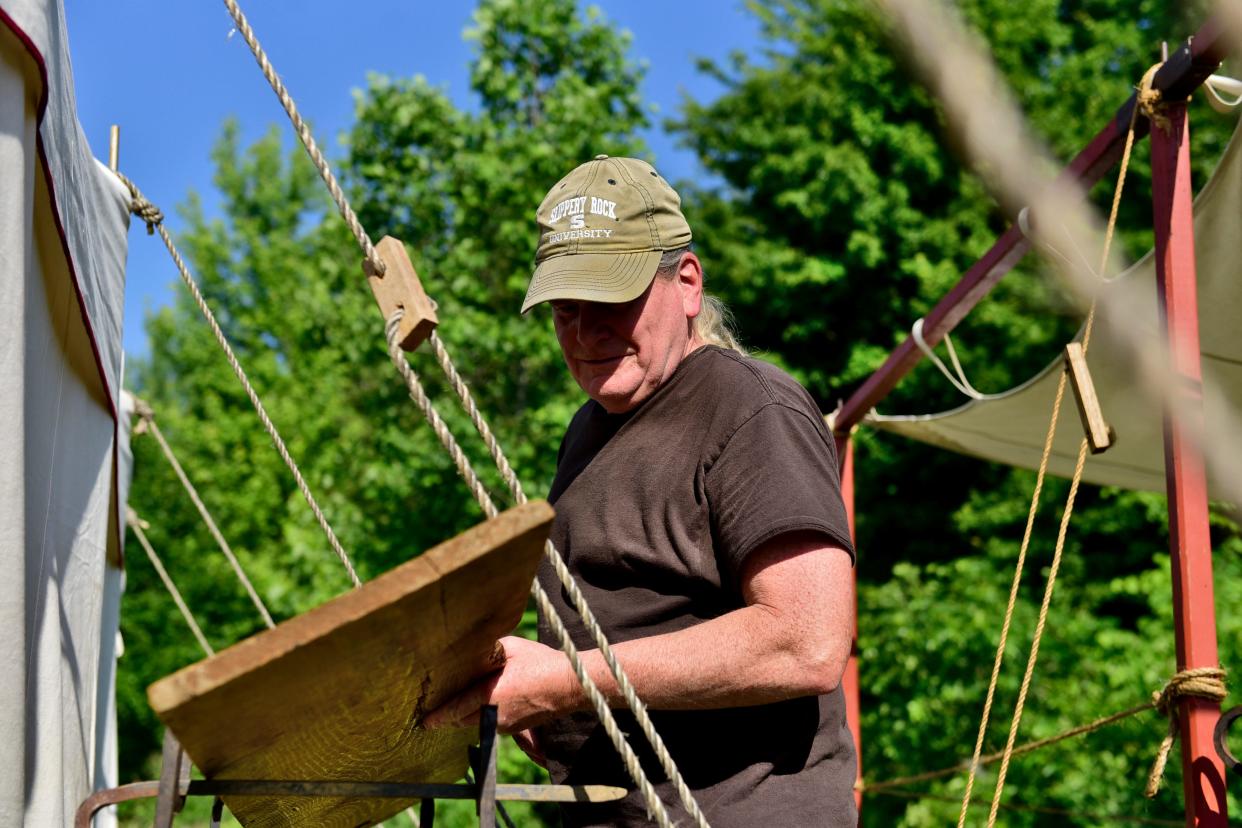 Normal Weidel installs a kitchen for his frontier camp Friday morning at Lowe-Volk Park. The display will be part of the Living History Days event, which runs through Sunday afternoon.