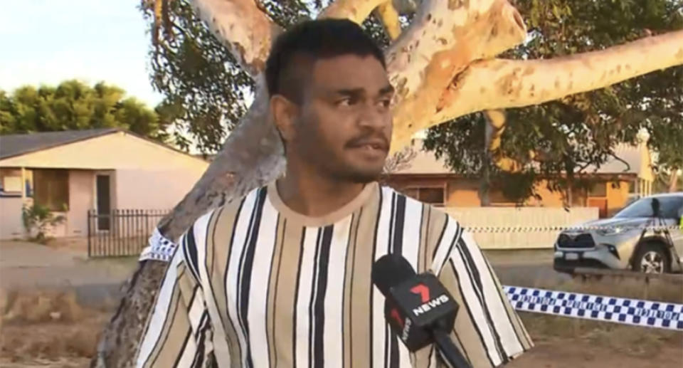 Man wearing striped shirt talking to a reporter about Cleo Smith rescue. 