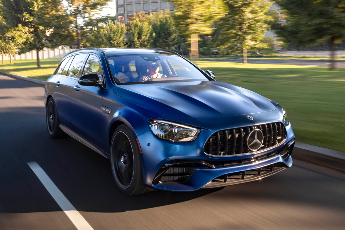 A blue 2021 Mercedes-AMG E63 S 4MATIC Wagon driving down the street. Want a high-performance station wagon? Read our review of this.