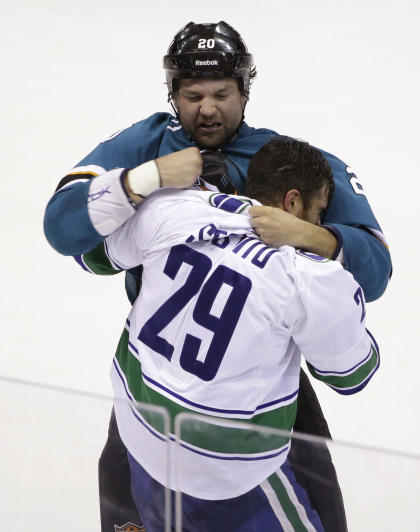 San Jose Sharks&#39; John Scott, top, fights with Vancouver Canucks&#39; Tom Sestito during the first period of an NHL preseason hockey game Tuesday, Sept. 23, 2014, in Stockton, Calif. (AP Photo/Marcio Jose Sanchez)