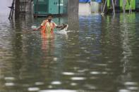 Mumbai: A man wades through a waterlogged street after heavy monsoon rain, at Sion in Mumbai, Wednesday, Sept. 23, 2020. (PTI Photo/Kunal Patil)(PTI23-09-2020_000076A)