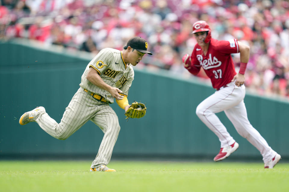 San Diego Padres second baseman Ha-Seong Kim, left, looks to throw Cincinnati Reds' Will Benson out at first base as Tyler Stephenson (37) advances to second base during the third inning of a baseball game Saturday, July 1, 2023, in Cincinnati. (AP Photo/Jeff Dean)