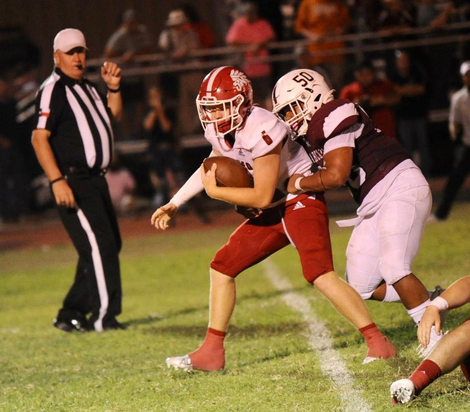 Hawley's Hez Parker tackles Jim Ned quarterback Grant Glidewell.