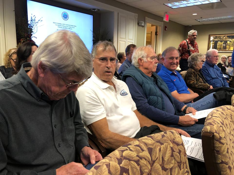 Soon-to-be-former City Manager Patrick Comiskey sits with supporters in the audience during the Mount Dora City Council meeting on Feb. 20, 2024. From left, Bob Gordon, Joe Lewis, Frank Kirwin and Comiskey.