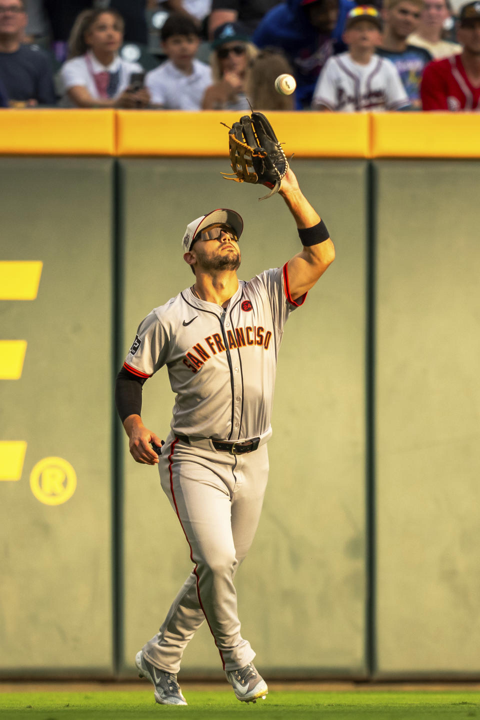 San Fransisco left fielder Forrest Wall catches a pop fly during the first inning of a baseball game against the Atlanta Braves, Thursday, July 4, 2024, in Atlanta. (AP Photo/Jason Allen)