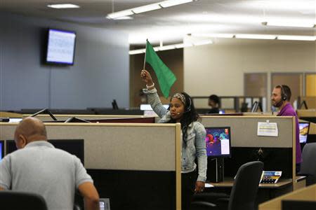 A customer service agent at Covered California's Concord call center waves a flag for technical assistance during the opening day of enrollment of the Patient Protection and Affordable Care Act in Concord, California October 1, 2013. REUTERS/Stephen Lam